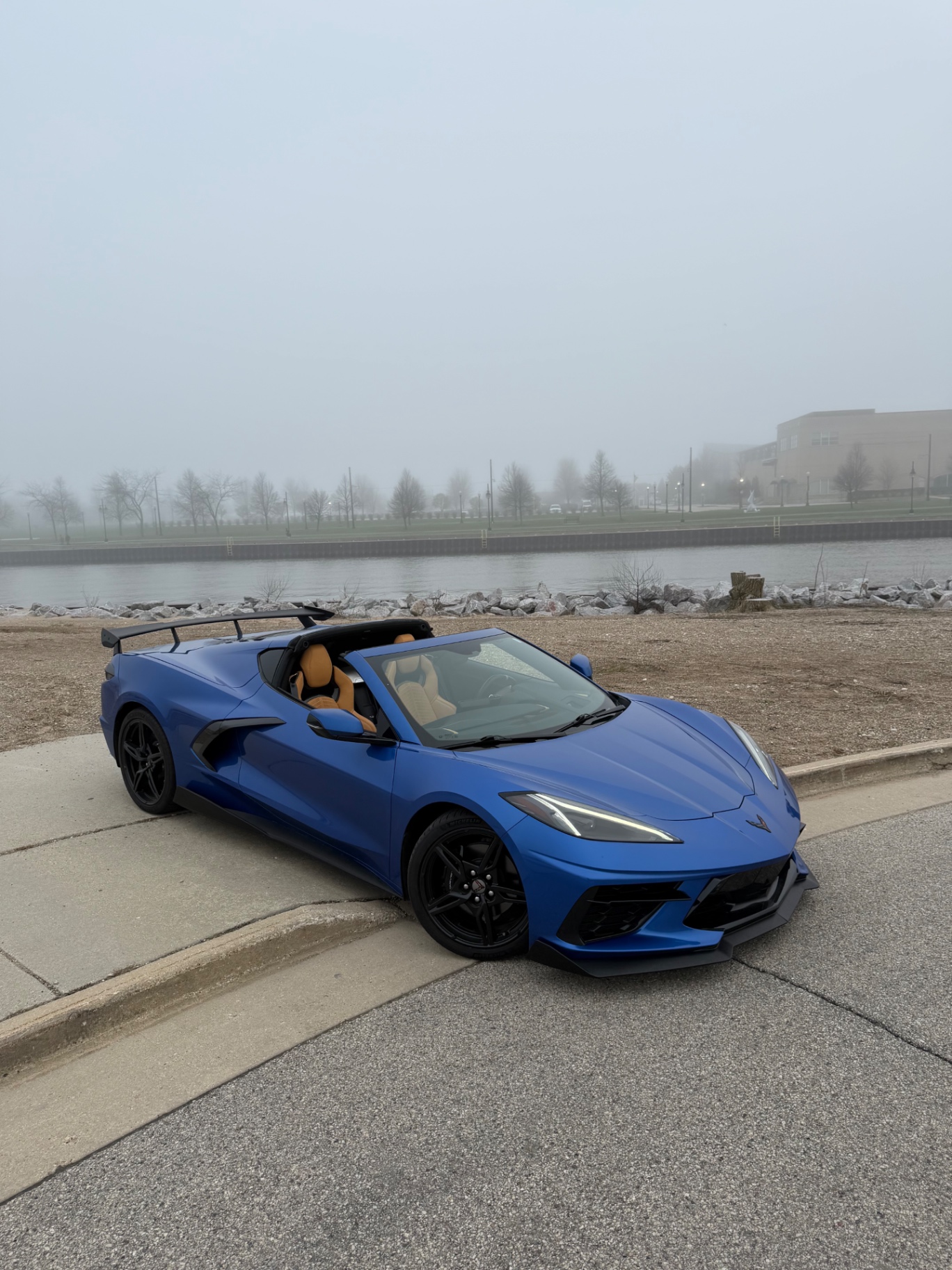 Blue 2023 Corvette C8 convertible parked along the Milwaukee harbor