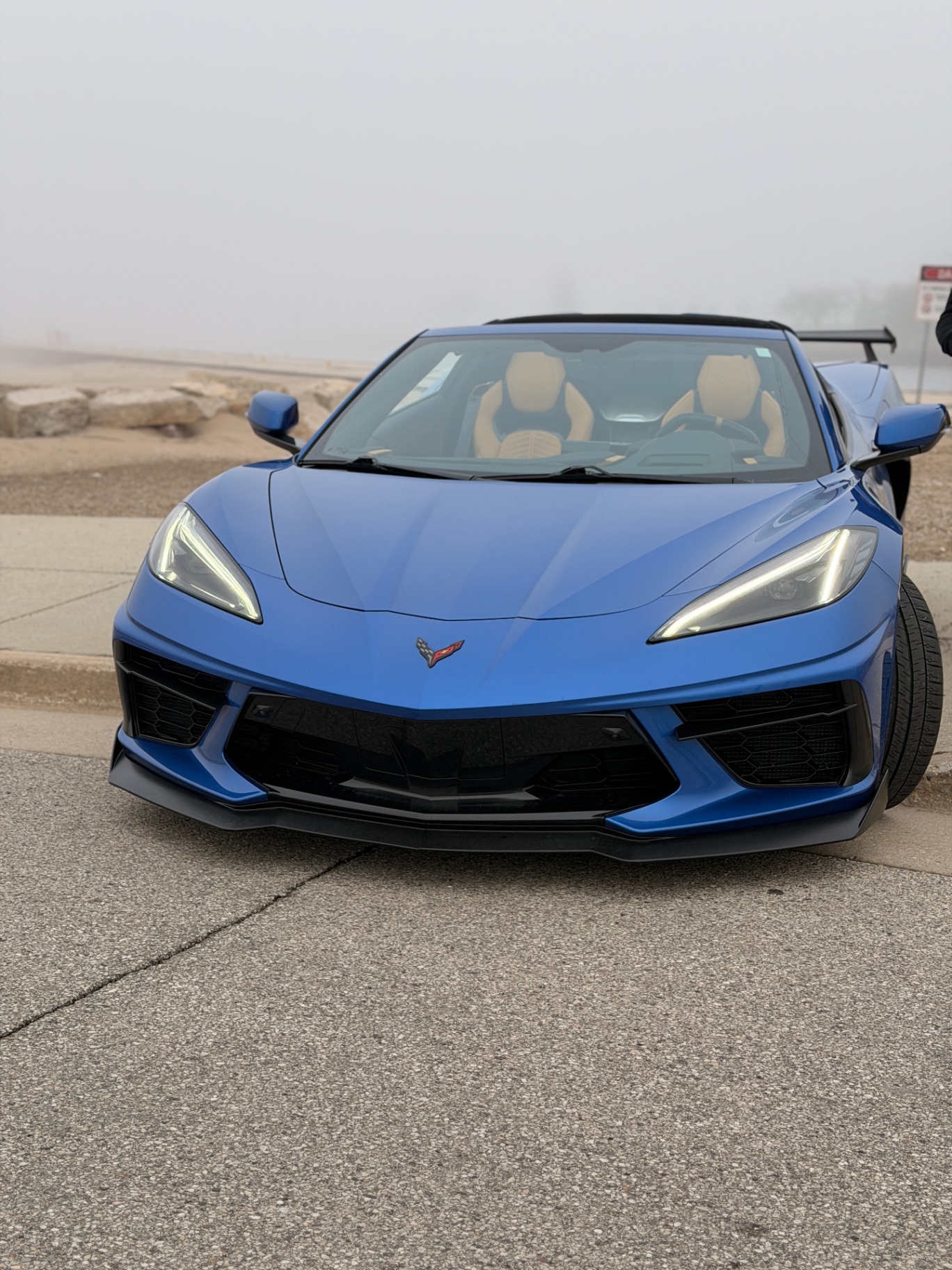 Front view of the blue Corvette C8 with the top down